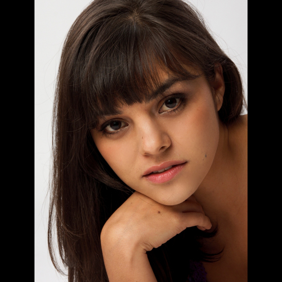 Headshot of a woman leaning on her hand.