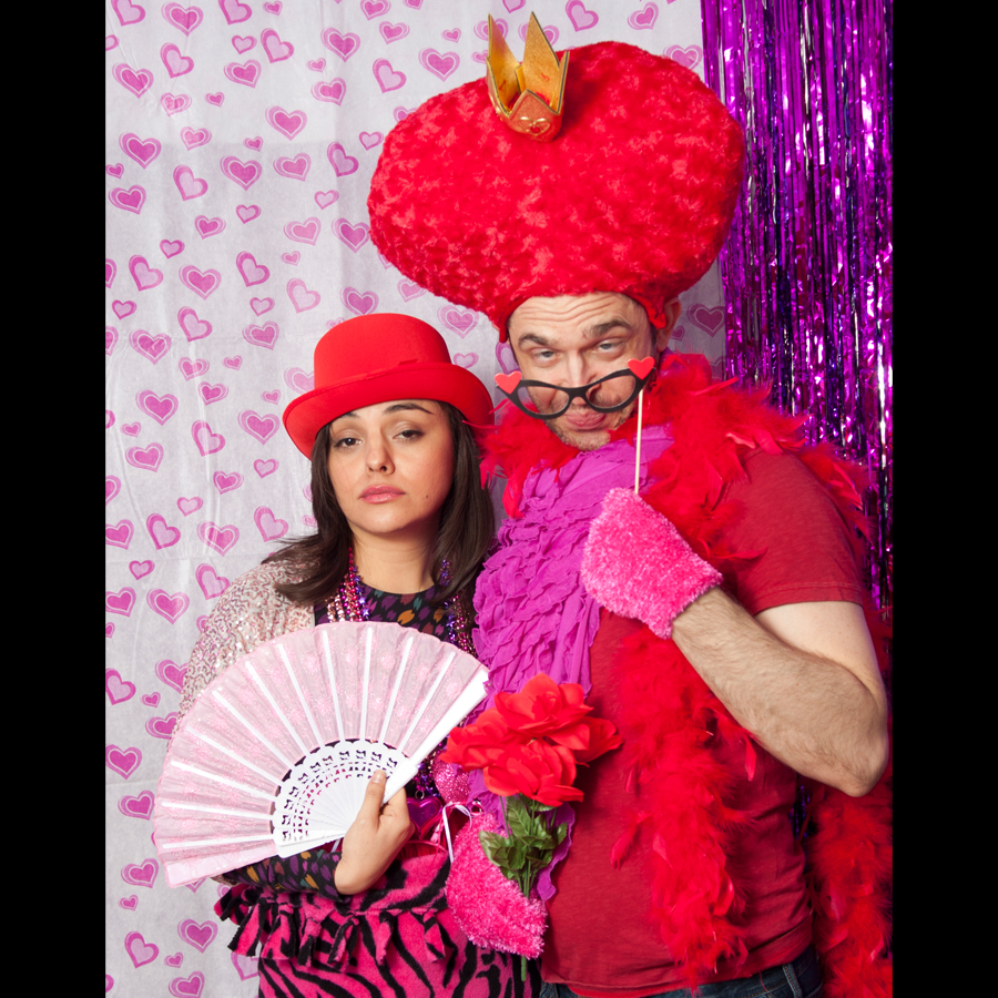A couple wearing Valentines props.