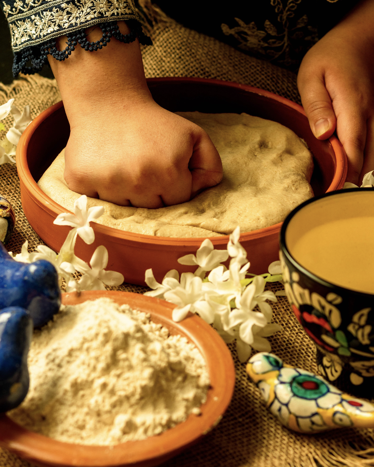 South Asian woman kneeding dough