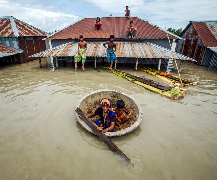 Floodwaters surrounding homes and boats in Bangladesh