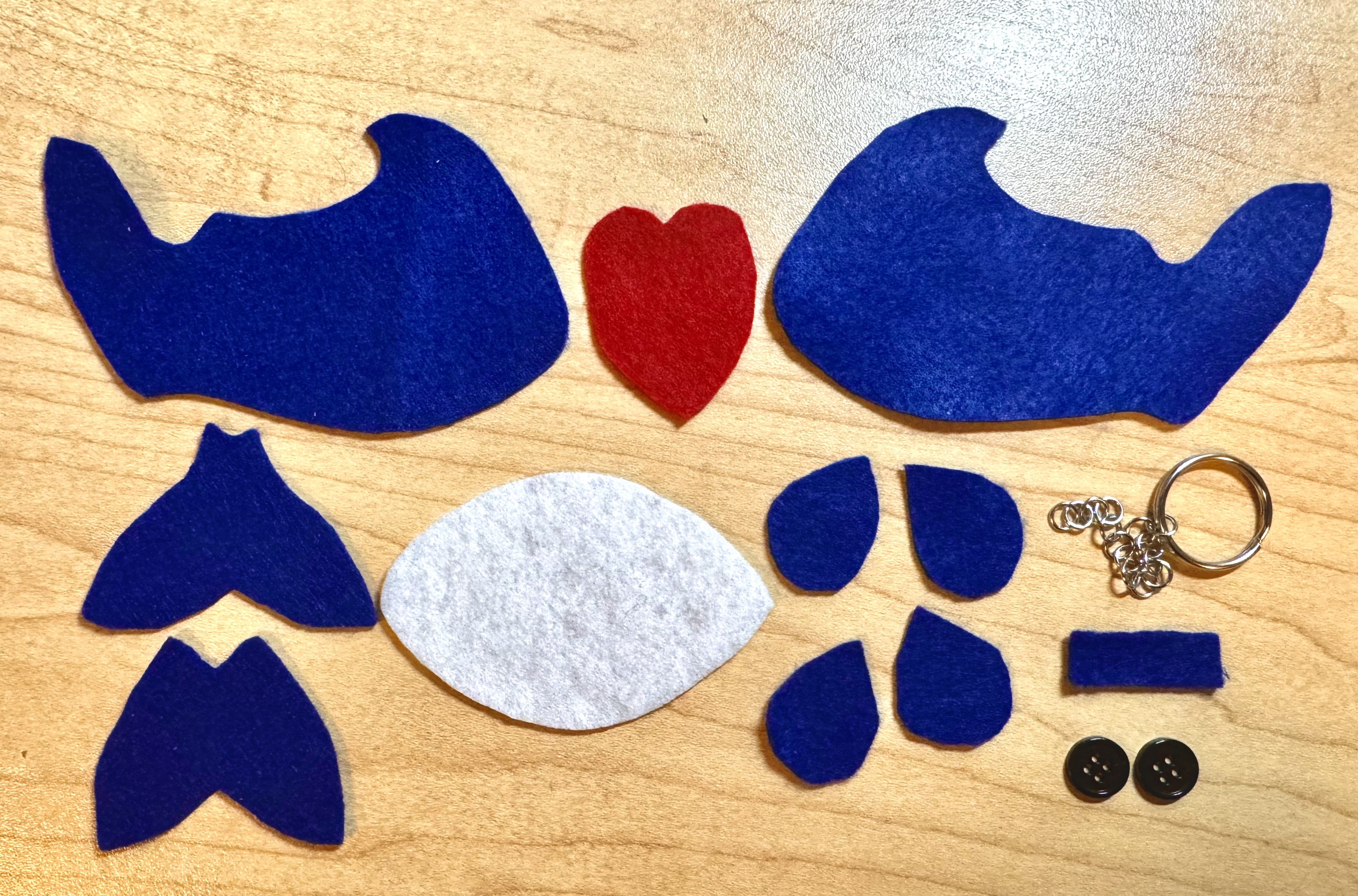laid out felt pieces and other materials which goes into making a whale with